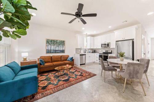 a living room with a couch and a table at C'est Bon House/2 KING Beds*Cajun Luxury*Coffee in Lafayette
