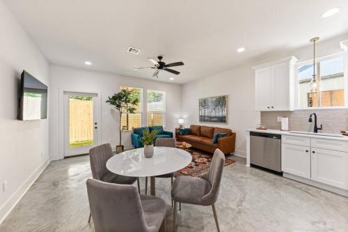 a kitchen and living room with a table and chairs at C'est Bon House/2 KING Beds*Cajun Luxury*Coffee in Lafayette