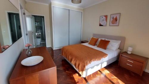 a small bedroom with a bed and a table at Villa Strelitzia in Funchal