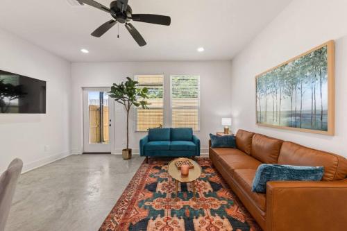 a living room with a couch and a ceiling fan at C'est Bon House/2 KING Beds*Cajun Luxury*Coffee in Lafayette