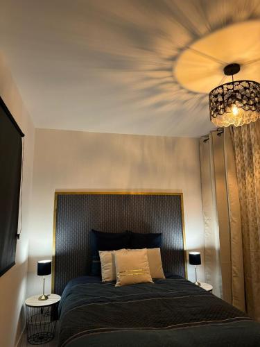 a bedroom with a large bed with a ceiling at La maison de LYA (lyaroom) 