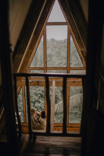 a window in a room with a view of a mountain at Camiguin Volcano Houses - A-Frame house in Mambajao