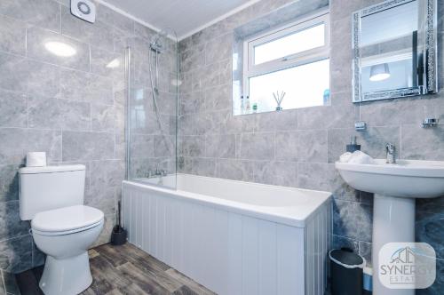 La salle de bains est pourvue de toilettes blanches et d'un lavabo. dans l'établissement Pacific House, Manchester - by Synergy Estates, à Manchester