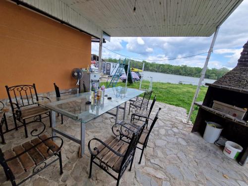 a patio with a table and chairs and a fireplace at Green camp & Sports Pri Popa in Vardim