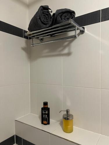 a shelf in a bathroom with a bottle of soap at Green terrace aircondition downtown metro C Budějovická in Prague