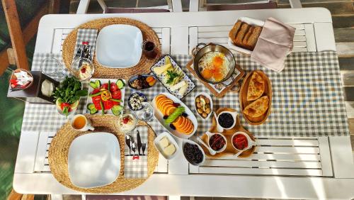 a table topped with plates of food on a table at Portalimo Lodge Hotel - Adult Only +12 in Cıralı