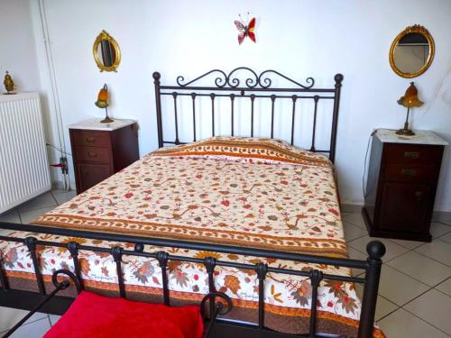 a bedroom with a bed and two dressers and a butterfly on the wall at Efi's apartment in Apróvaton