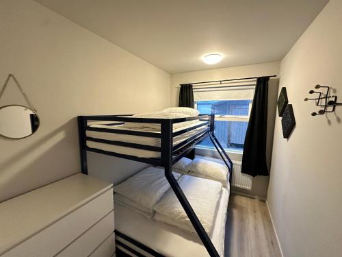 a small room with two bunk beds in it at Selbraut - Birta Rentals in Reykjavík