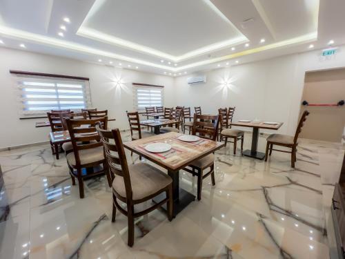 a dining room with wooden tables and chairs at Petra Premium Hotel in Wadi Musa