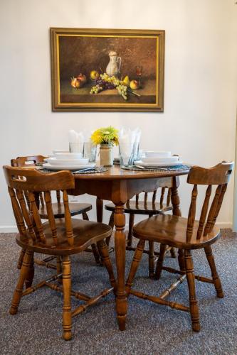 a wooden table with two chairs and a painting on the wall at Hendo Hideaway A 2bed/1bath in Hendersonville