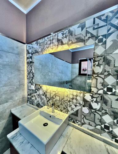 a bathroom with a sink and a mirror at Marsala al centro n 9 in Marsala