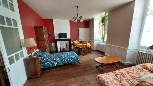 a living room with a couch and a table at Les Gites du château in Châteaumeillant