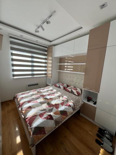 a bedroom with a large bed and a window at Jovanovic Titova Vila in Palisad