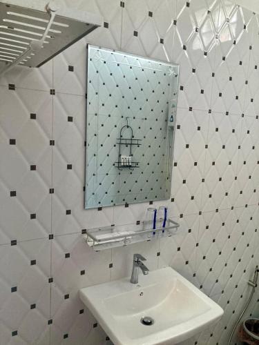a bathroom with a sink and a mirror at Lotus Haven Villa in Siem Reap
