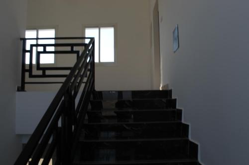a staircase in a building with two windows at Dreams Resorts in Sinādil