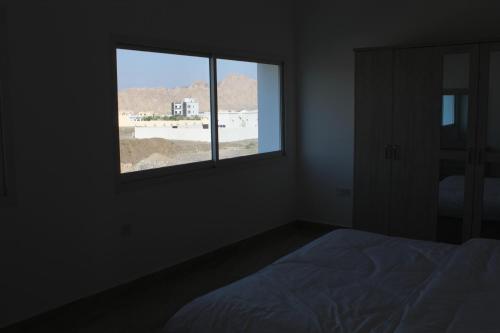 a bedroom with a window with a bed and a view at Dreams Resorts in Sinādil