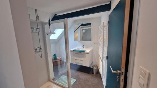 a small bathroom with a sink and a mirror at Le Tiyou in Spa