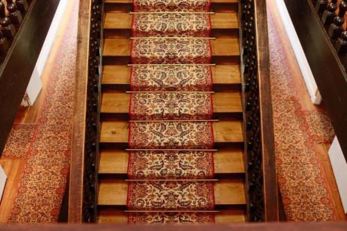 an overhead view of a stairway with red carpet at Grand Hôtel de la Poste in Saint-Jean-de-Luz