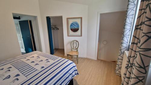 a bedroom with a bed and a chair in it at Le Tiyou in Spa