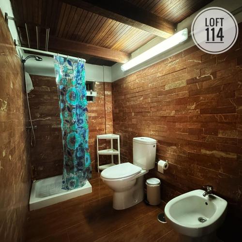 a bathroom with a toilet and a sink at LOFT-114 in Santa Cruz de Tenerife