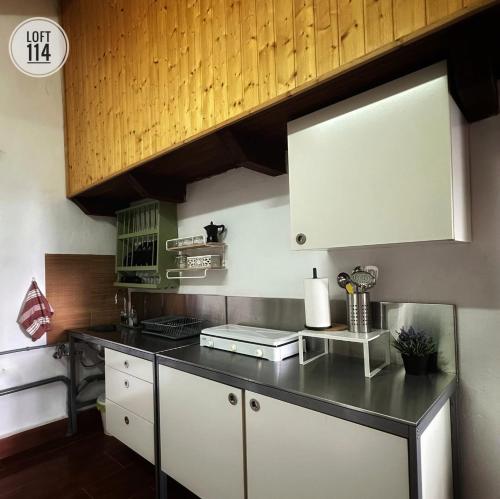 a kitchen with a black counter top and white cabinets at LOFT-114 in Santa Cruz de Tenerife