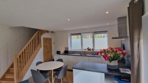 a kitchen with a table and some chairs and a table at Le Tiyou in Spa