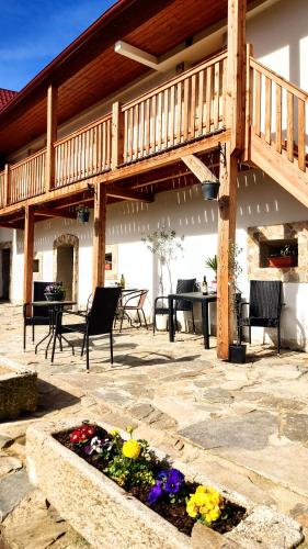 a patio with a deck and a table and flowers at Jílová tvrz in Rožmberk nad Vltavou