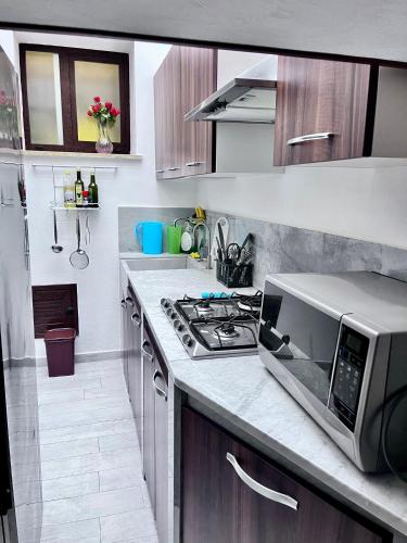 a kitchen with a microwave oven and a stove at Marsala al centro n 9 in Marsala