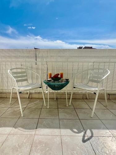 two chairs and a table with candles on a patio at City lux apartment 2 in Serres