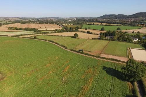 an aerial view of a green field with a road at Bertha's Box in Ross on Wye