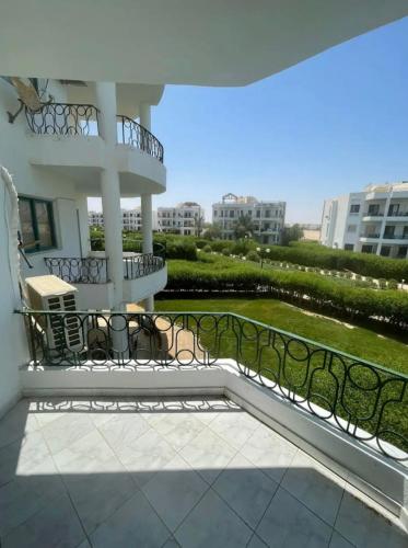 a balcony of a building with a table and chairs at Two bedroom Chalet in Golden Beach Ras Sedr Fully Air conditioned in front of the pool near the beach kids aqua kids areas family cafeteria in Ras Sedr
