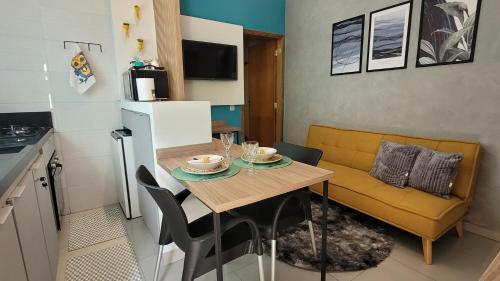 een klein appartement met een tafel en een bank bij Estúdio completo próximo da Universidade WiFi in Sao Paulo
