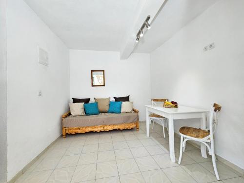 a room with a bed and a desk and a table at Lemon Nest in Marathokampos
