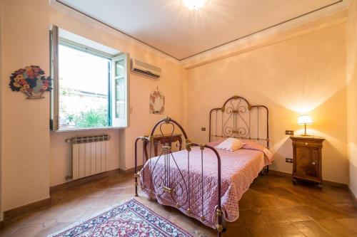 a bedroom with a bed and a window at Villa Carla, a charming villa in the center of Taormina in Taormina