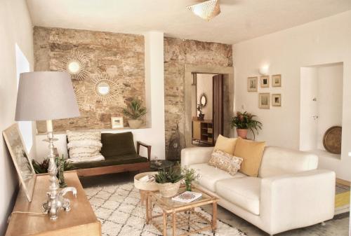 a living room with a couch and a table at Farmacia Beach House in Odemira