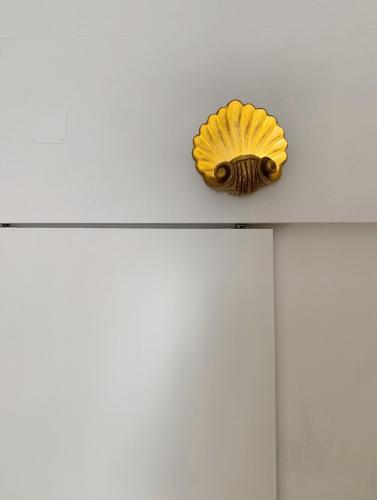 a yellow shell on top of a white ceiling at Farmacia Beach House in Odemira