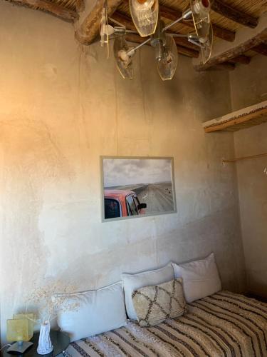 a living room with a couch and a picture on the wall at Farmacia Beach House in Odemira