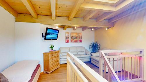 a bedroom with a bunk bed and a couch at Appartements Hofer in Viehhofen