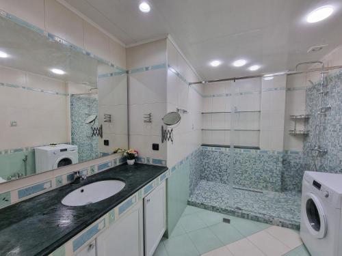 a bathroom with a sink and a shower at Central sea view in Baku