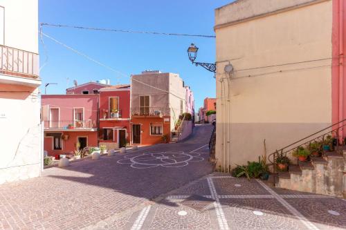 an empty street in a town with buildings at Montellino's Suite Oro in SantʼAntìoco