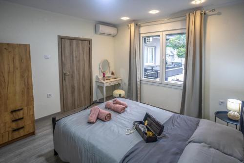 a bedroom with a bed with two pink pillows on it at House & Garden in Kavála