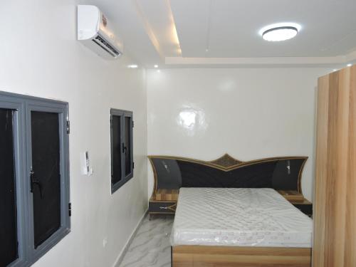 a bedroom with a bed and a window at Résidence Les Oliviers by Jad Inn in Nouakchott