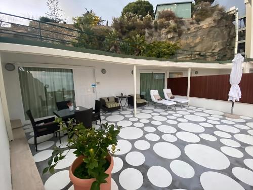a patio with chairs and tables on a building at Grand Hotel Del Mare Resort & Spa in Bordighera