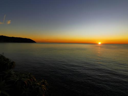 a sunset over a large body of water at Grand Hotel Del Mare Resort & Spa in Bordighera