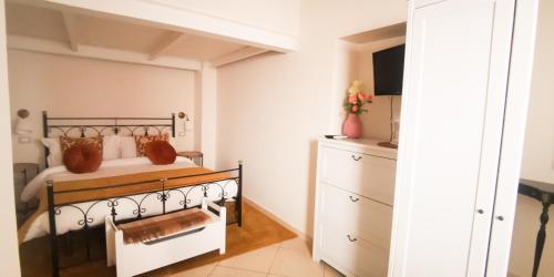 a bedroom with a bed and a dresser at Donna Rosa - Main Avenue in Taormina