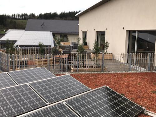 a group of solar panels on the roof of a house at Ferienwohnungen Walz in Pfullendorf