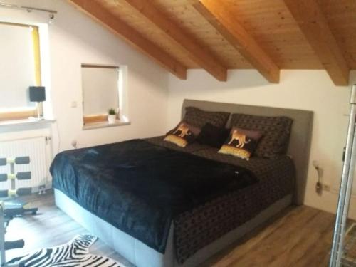 a bedroom with a large bed with pillows on it at Apartment in den bayerischen Alpen, für Naturliebhaber in Schneizlreuth