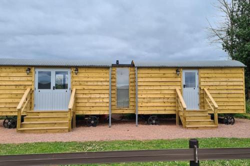 a wooden house with two windows and a fence at Shepherd's View in Ross on Wye