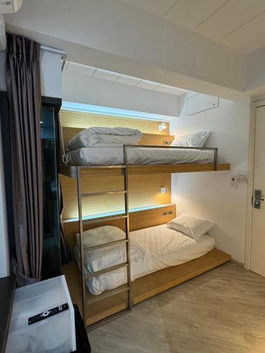 a room with three bunk beds in a room at One More Space in Chiang Mai