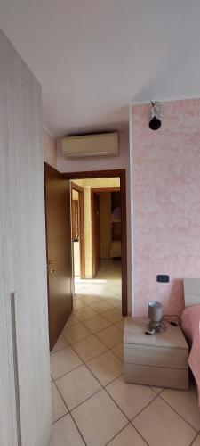 a living room with a room with a couch at Appartamento Althea in Basiano